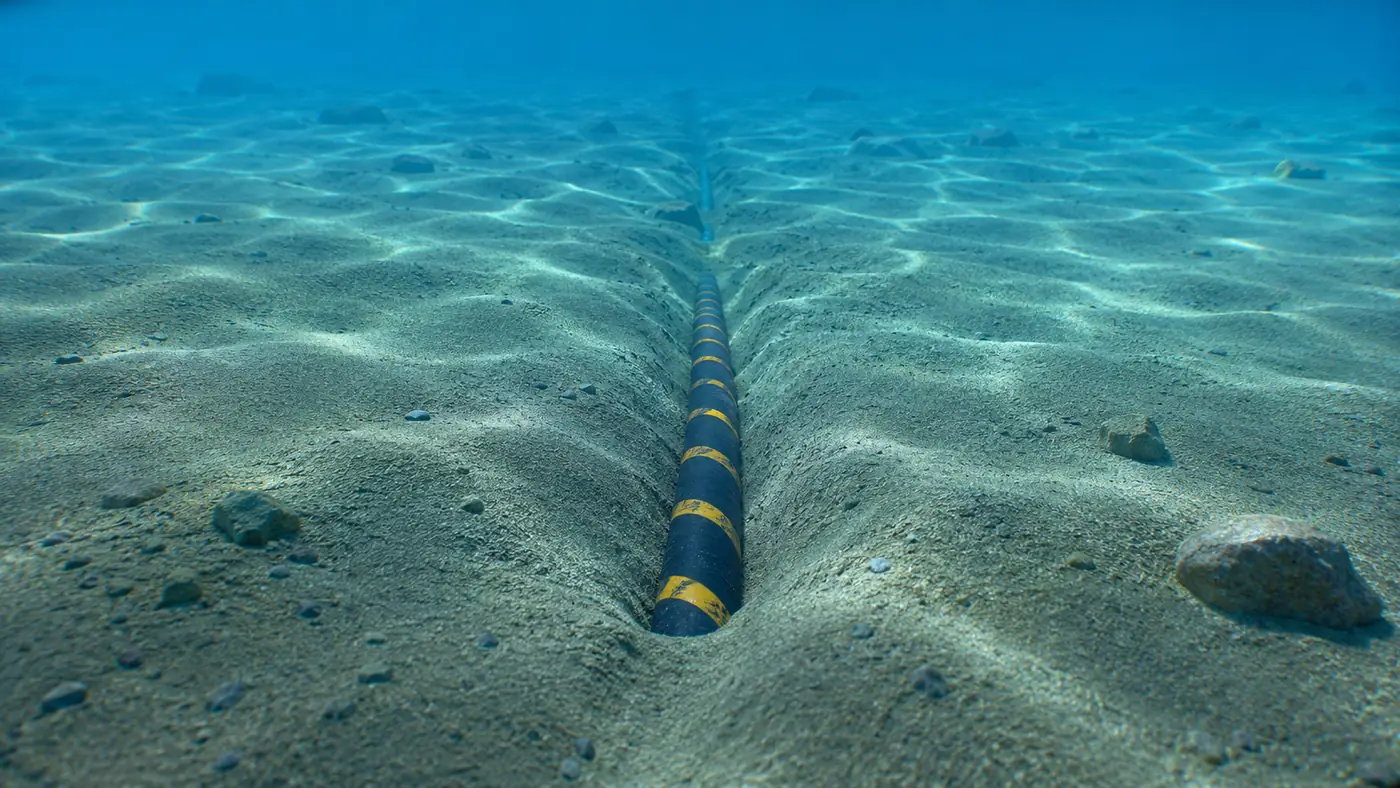 Submarine power cable laid in a seabed trench